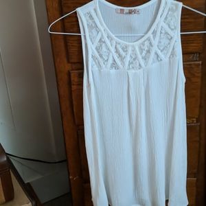 White sleeveless top with sheer yoke